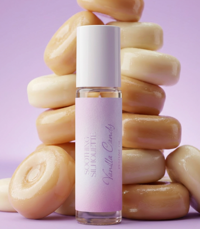 Vanilla Candy 10 milliliter perfume oil bottle. Vanilla candies as photo props on a light purple background. Original Price: $14. Comes in a roll-on glass bottle. Notes are Berries, jasmine, peony, vanilla and musk. Ingredients are Isopropyl Myristate and Fragrance